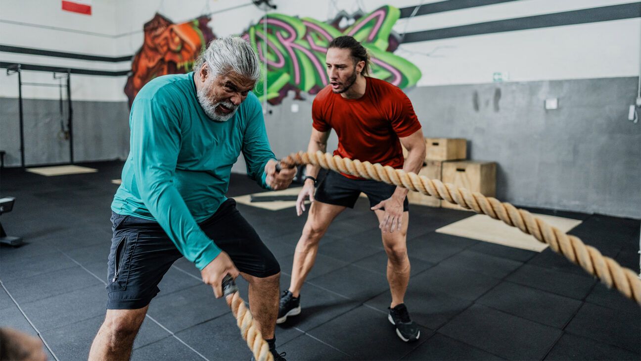 Elderly man training with a battle rope